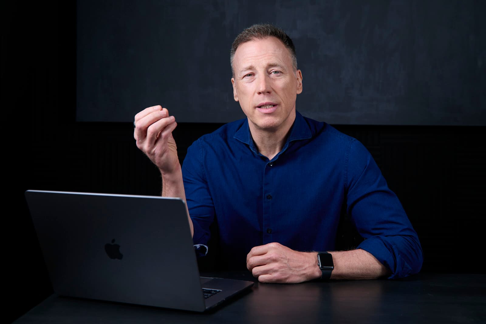 Speaker on Stage with Presentation Screen